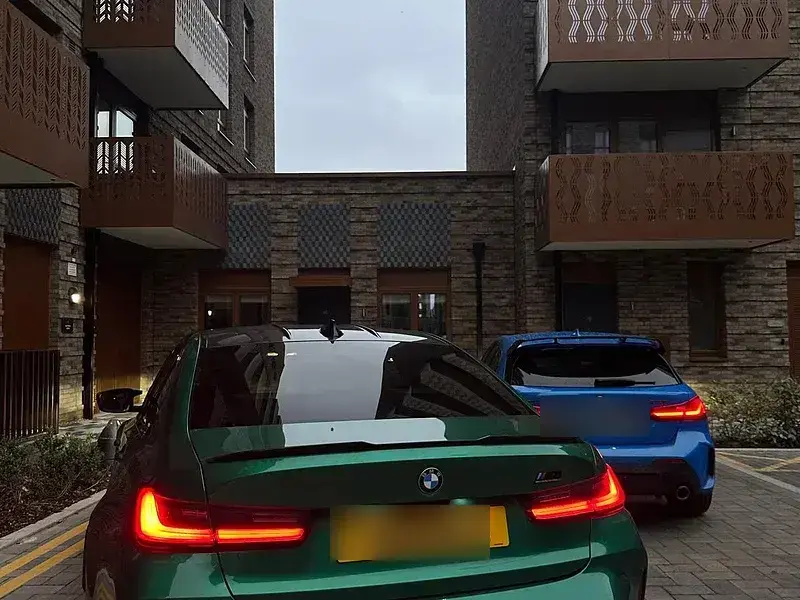 A green BMW M3 with tinted rear windows