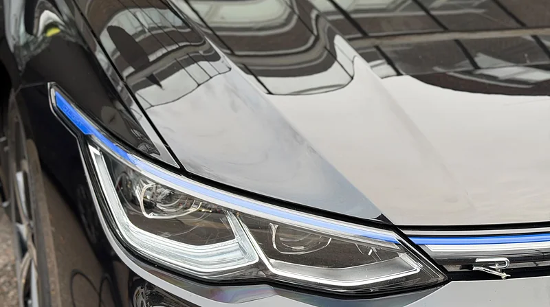 Sharp reflections in the deep gloss of a freshly protected black bonnet