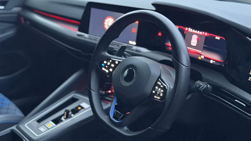 Golf R dashboard and steering wheel lit with red ambient lighting